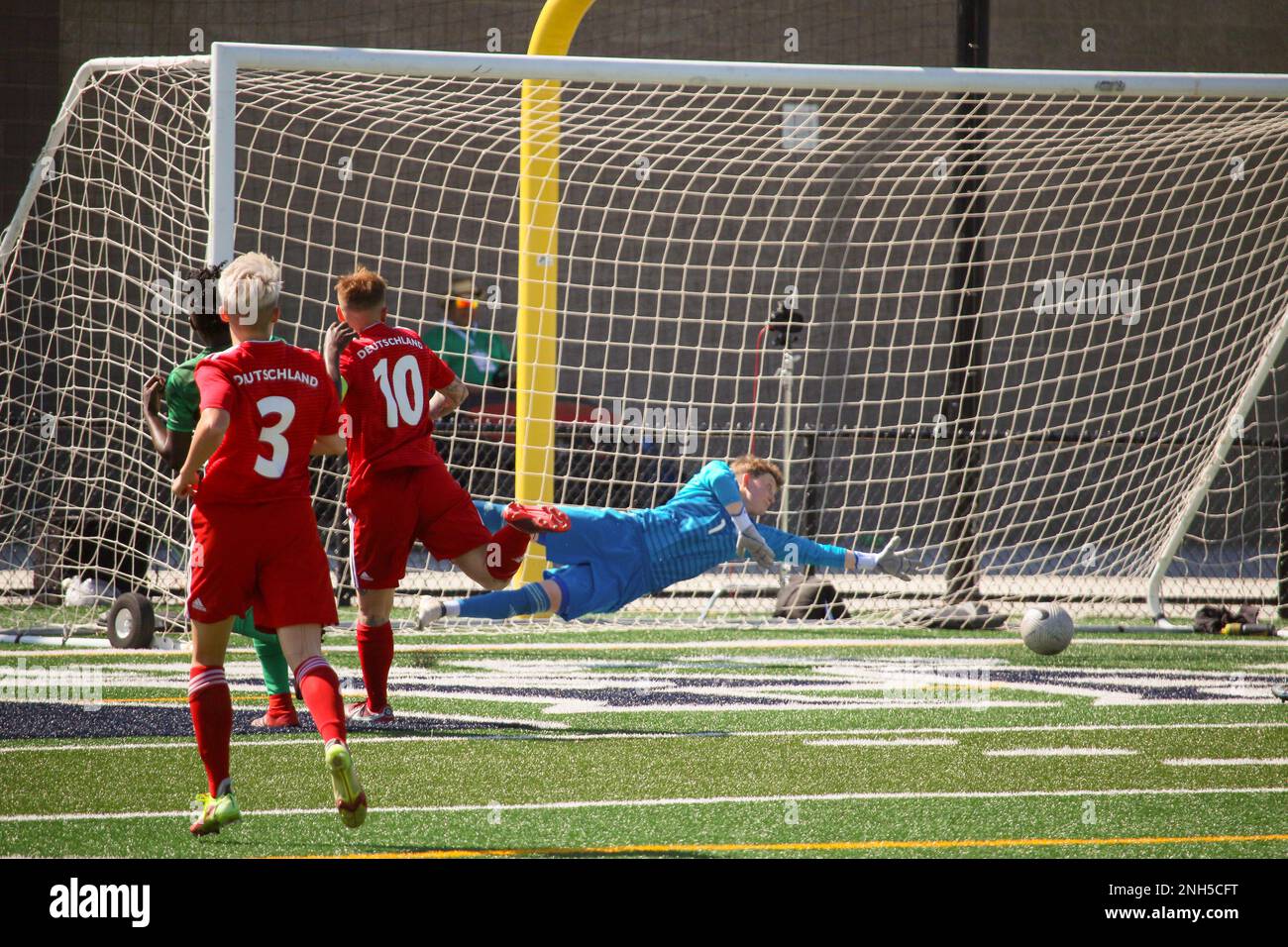 Cameroon's Ebika Tabe scores past the diving German goalkeeper, Gina-Marie Mitschke in match 13 of the 13th Conseil International du Sport Militaire (CISM) World Women's Military Football Championship hosted by Fairchild Air Force Base in Spokane, Washingon.  This year's championship features teams from the United States, Belgium, Cameroon, Canada, France, Germany, Ireland, Mali, Netherlands, and South Korea.  (Department of Defense Photo by Mr. Steven Dinote, released). Stock Photo