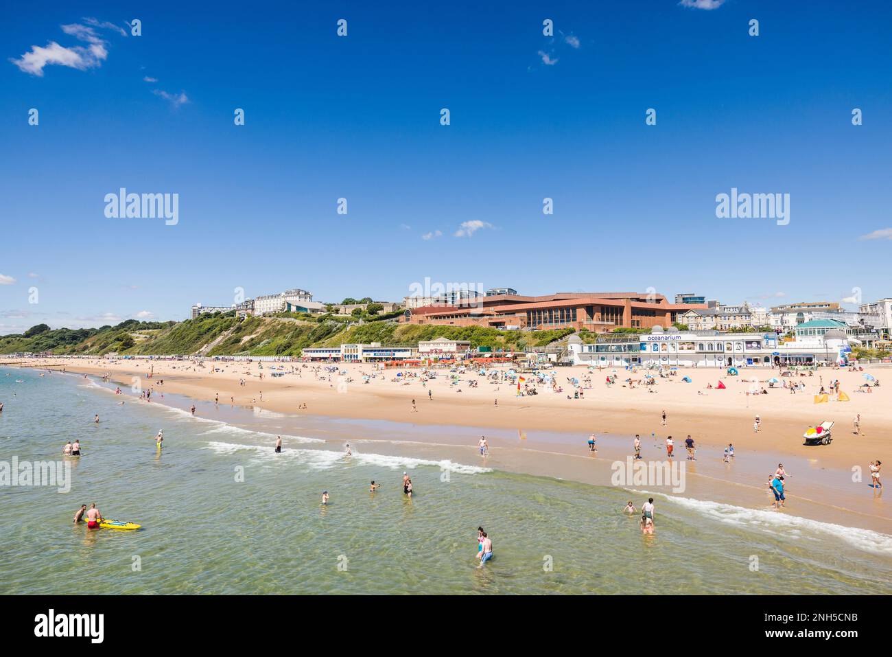 BOURNEMOUTH, UK - July 08, 2022. People enjoying summer by the sea on a sandy beach. Bournemouth, Dorset, UK Stock Photo