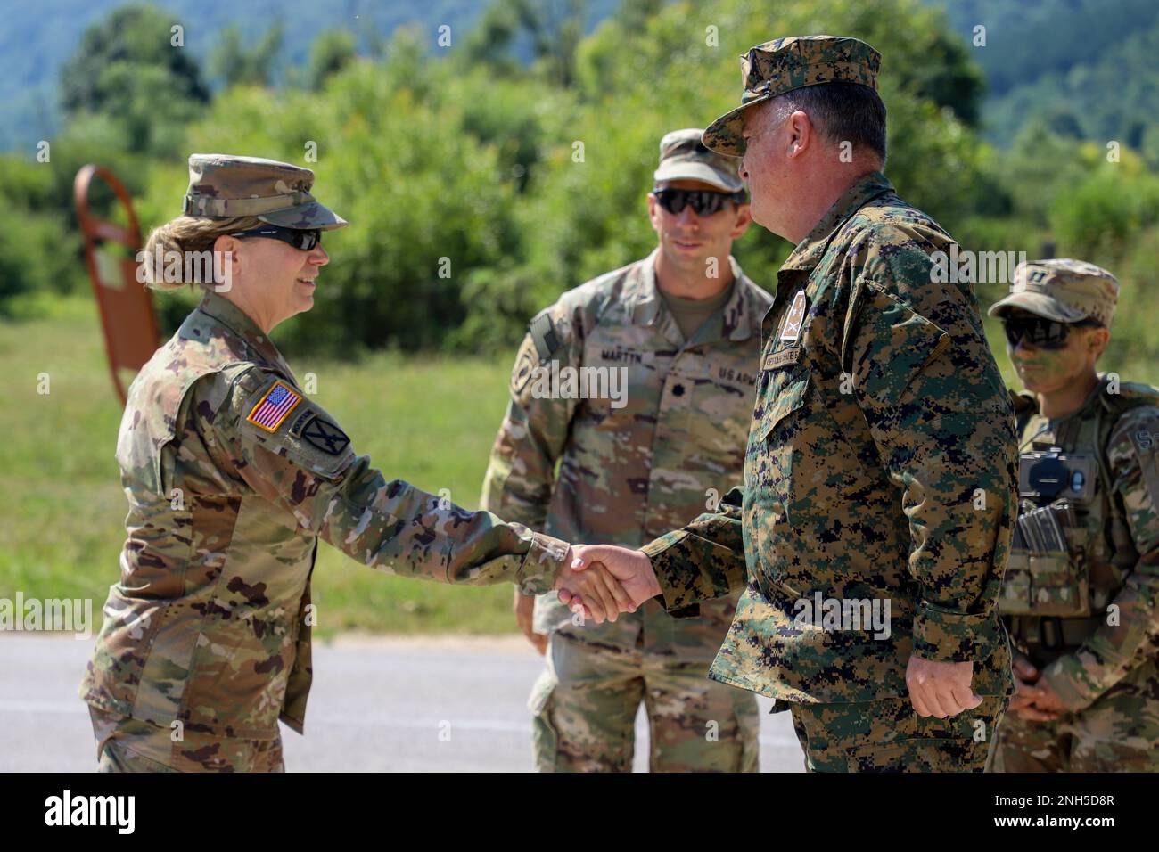 Brig. Gen. Pamela L. McGaha (left), Commander of NATO HQ Sarajevo, conducts a site visit at Kasarna Manjaca, Dobrnja, Bosnia-Herzegovina on July 17, 2022. Guard members assigned to the State Medical Detachment and 1-169th Aviation Regiment, Maryland Army National Guard, trained alongside active duty Soldiers from the 1st Squadron, 91st Cavalry Regiment, 173rd Airborne Brigade, 12th Combat Aviation Brigade, and the Armed Forces of Bosnia and Herzegovina soldiers in tactics, aviation, medical, and non-commissioned officer development. The Maryland National Guard will celebrate 20 years of partne Stock Photo