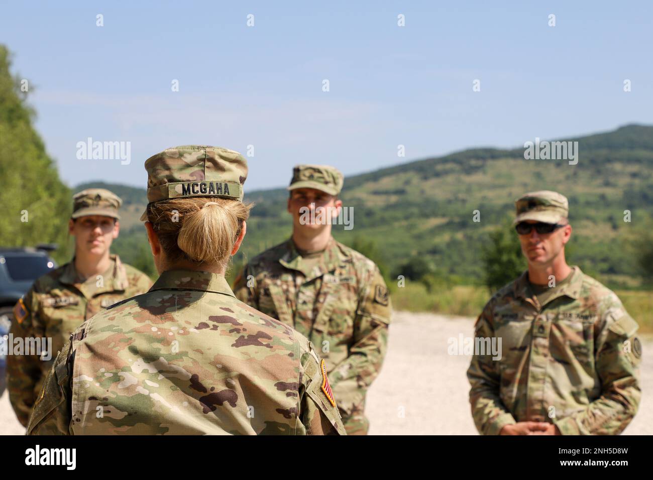 Brig. Gen. Pamela L. McGaha (center front), Commander of NATO HQ Sarajevo, visit guard members assigned to the State Medical Detachment and 1-169th Aviation Regiment, Maryland Army National Guard at Kasarna Manjaca, Dobrnja, Bosnia-Herzegovina on July 17, 2022. Guard members assigned to the State Medical Detachment and 1-169th Aviation Regiment, Maryland Army National Guard, trained alongside active duty Soldiers from the 1st Squadron, 91st Cavalry Regiment, 173rd Airborne Brigade, 12th Combat Aviation Brigade, and the Armed Forces of Bosnia and Herzegovina soldiers in tactics, aviation, medic Stock Photo