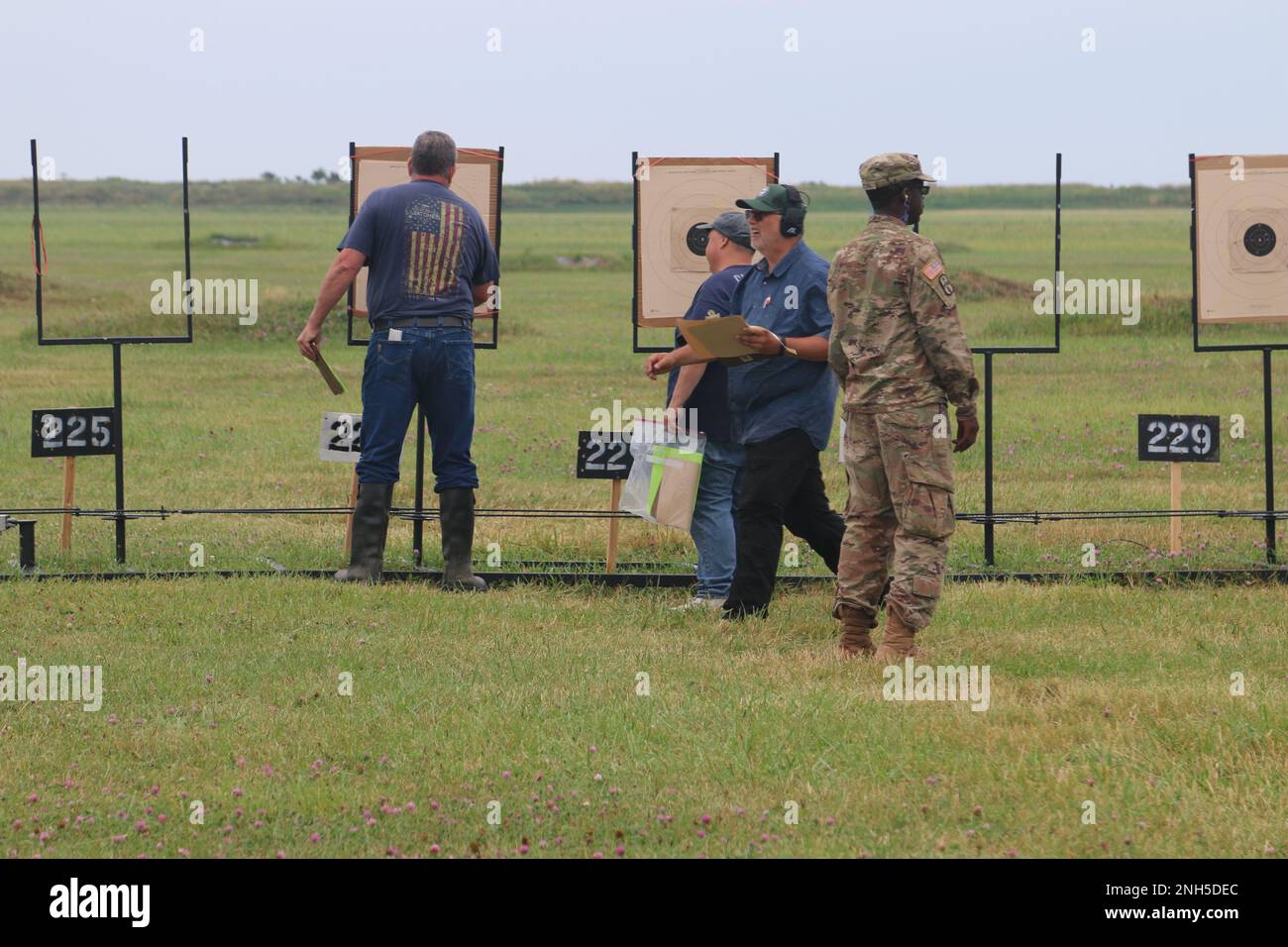 Competitors review their targets during the military and police pistol