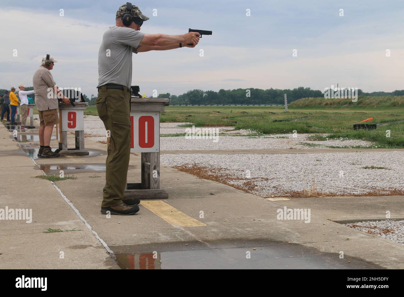 Competitors fire at the popup targets within their lanes during the