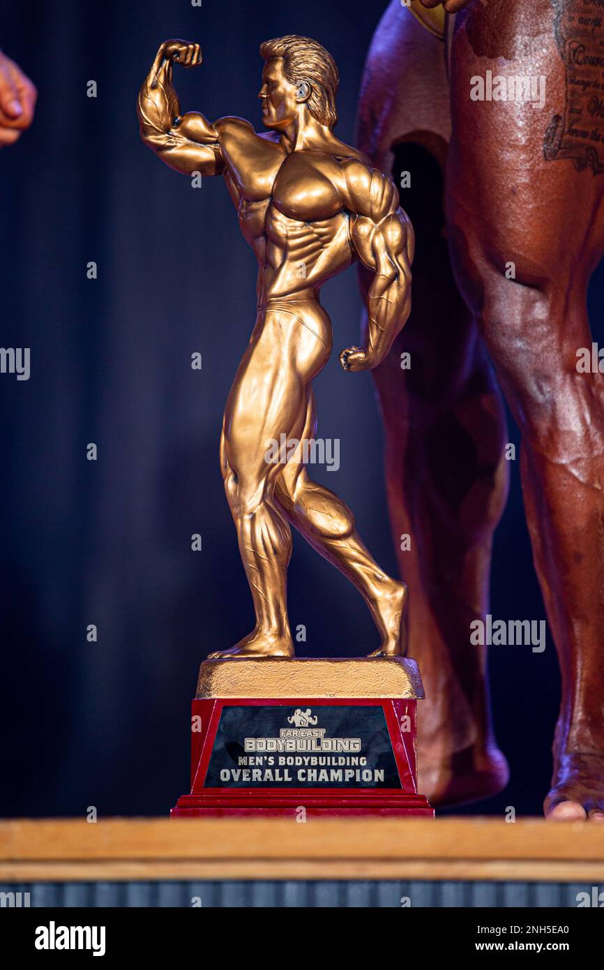 The men’s bodybuilding overall champion trophy is presented during the