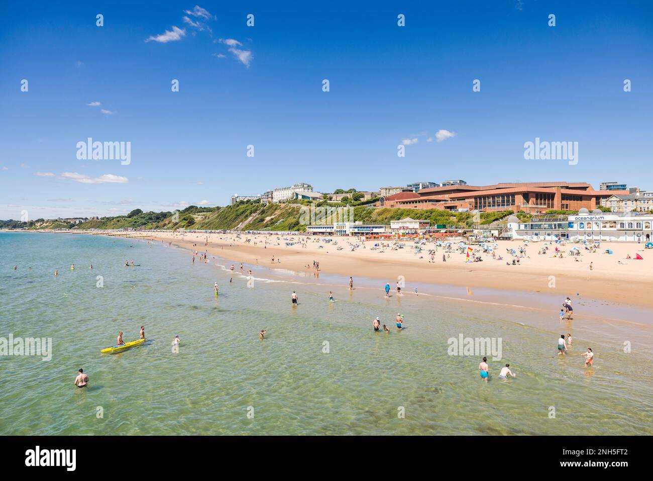 BOURNEMOUTH, UK - July 08, 2022. People enjoying summer by the sea on a sandy beach. Bournemouth, Dorset, UK Stock Photo