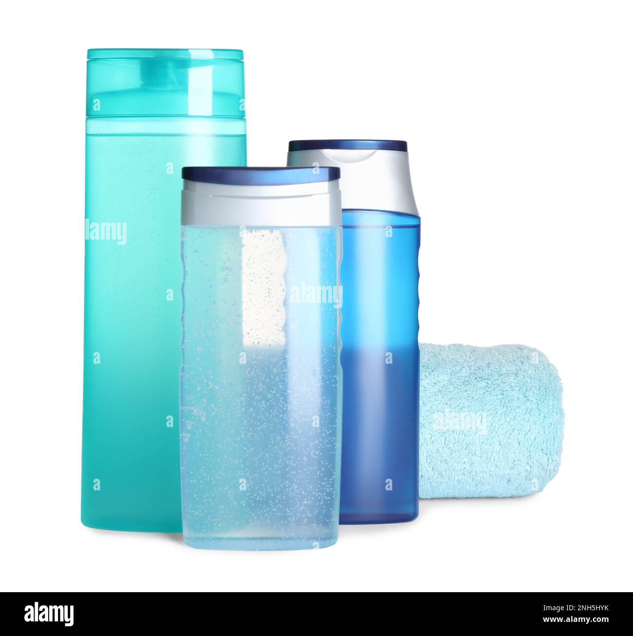 Different shower gel bottles and towel on white background Stock Photo