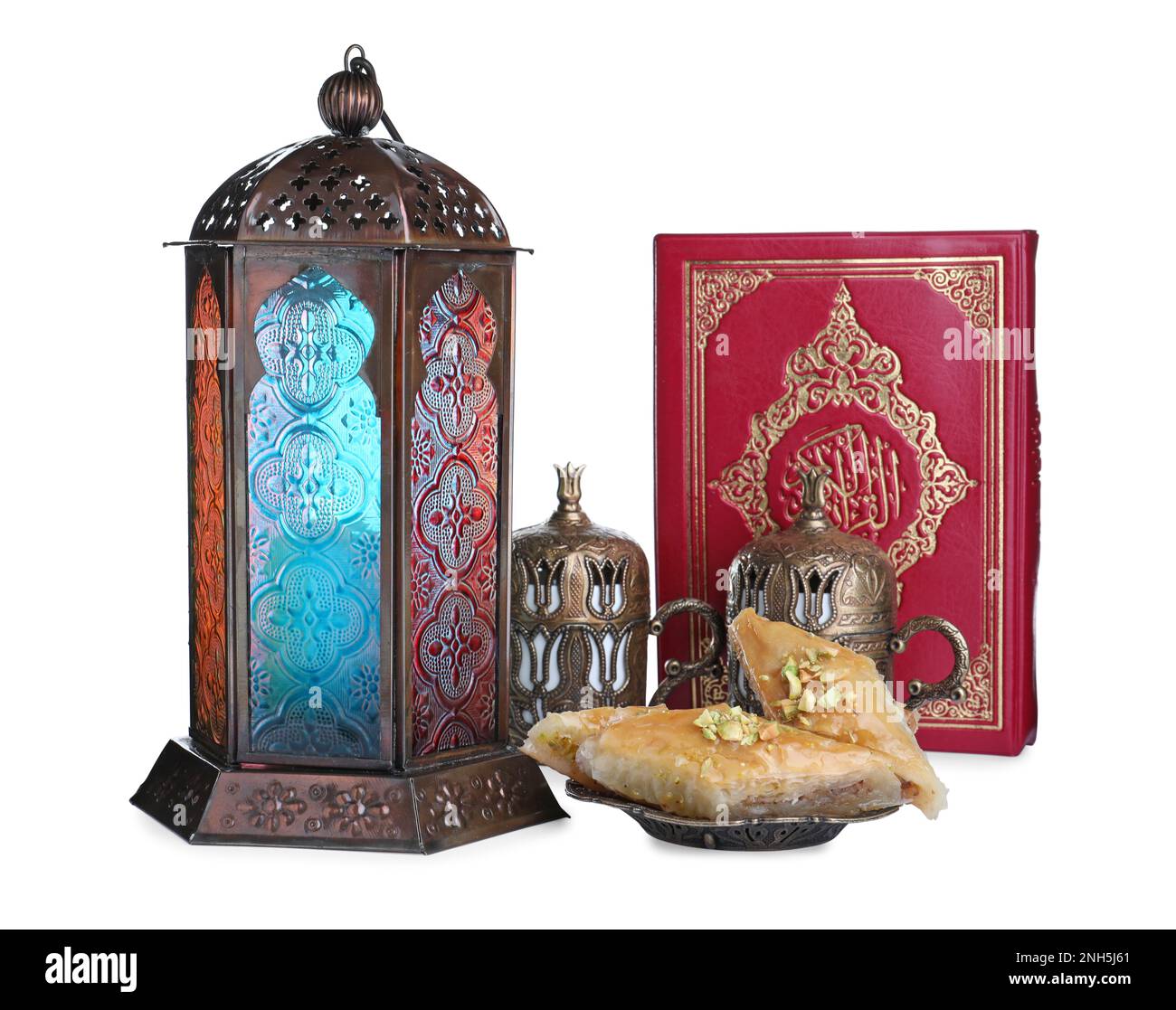 Decorative Arabic lantern, Quran, baklava and coffee on white