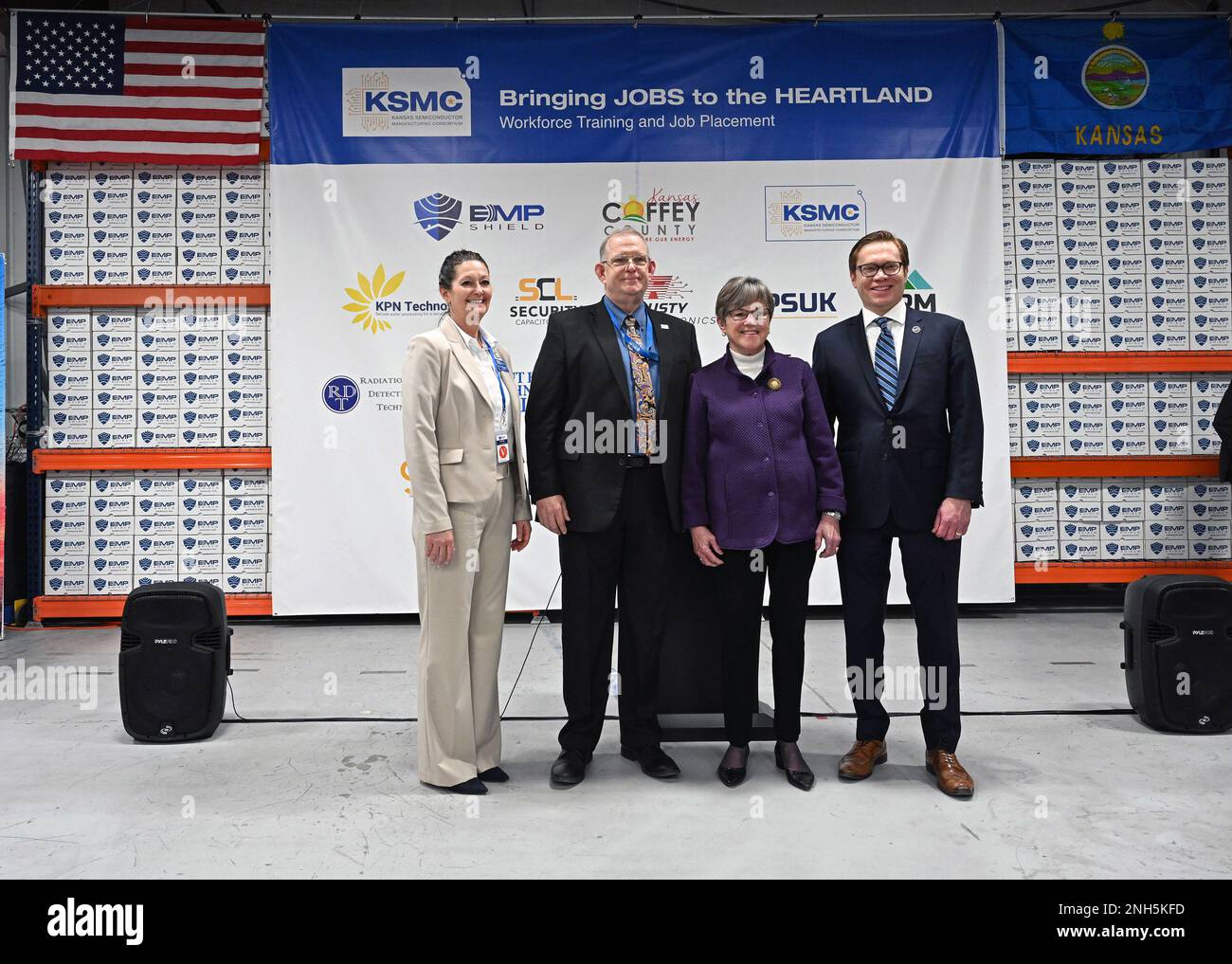 BURLINGTON, KANSAS - FEBRUARY 20, 2023 Kansas Governor Laura Kelly (center purple jacket) is flanked by Dr. Caron Daughter president of Flint Hills Technical College, Tim Carty Founder of EMP Shield and Leiutenant Governor David Toland at the EMP shield plant after announcing the new $1.9 billion dollar semiconductor project manufacturing facility that will be soon be opening in Coffey County. Stock Photo