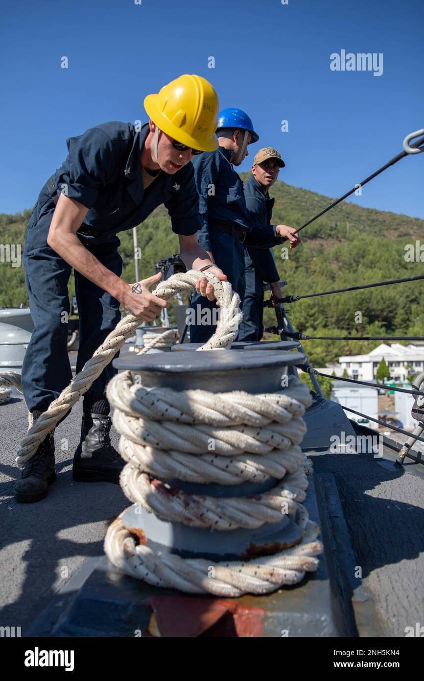 220718-N-QI593-1137 MARMARIS, TURKEY (July 18, 2022) Boatswain's Mate 2nd Class Michael Marcalus, from Berkeley Springs, West Virginia, nests mooring line on the fo’c’sle aboard the Arleigh Burke-class guided missile destroyer USS Bainbridge (DDG 96), during a scheduled port visit in Marmaris, Turkey, July 18, 2022. Bainbridge is on a scheduled deployment in the U.S. Naval Forces Europe area of operations, employed by U.S. Sixth Fleet to defend U.S., allied and partner interests. Stock Photo