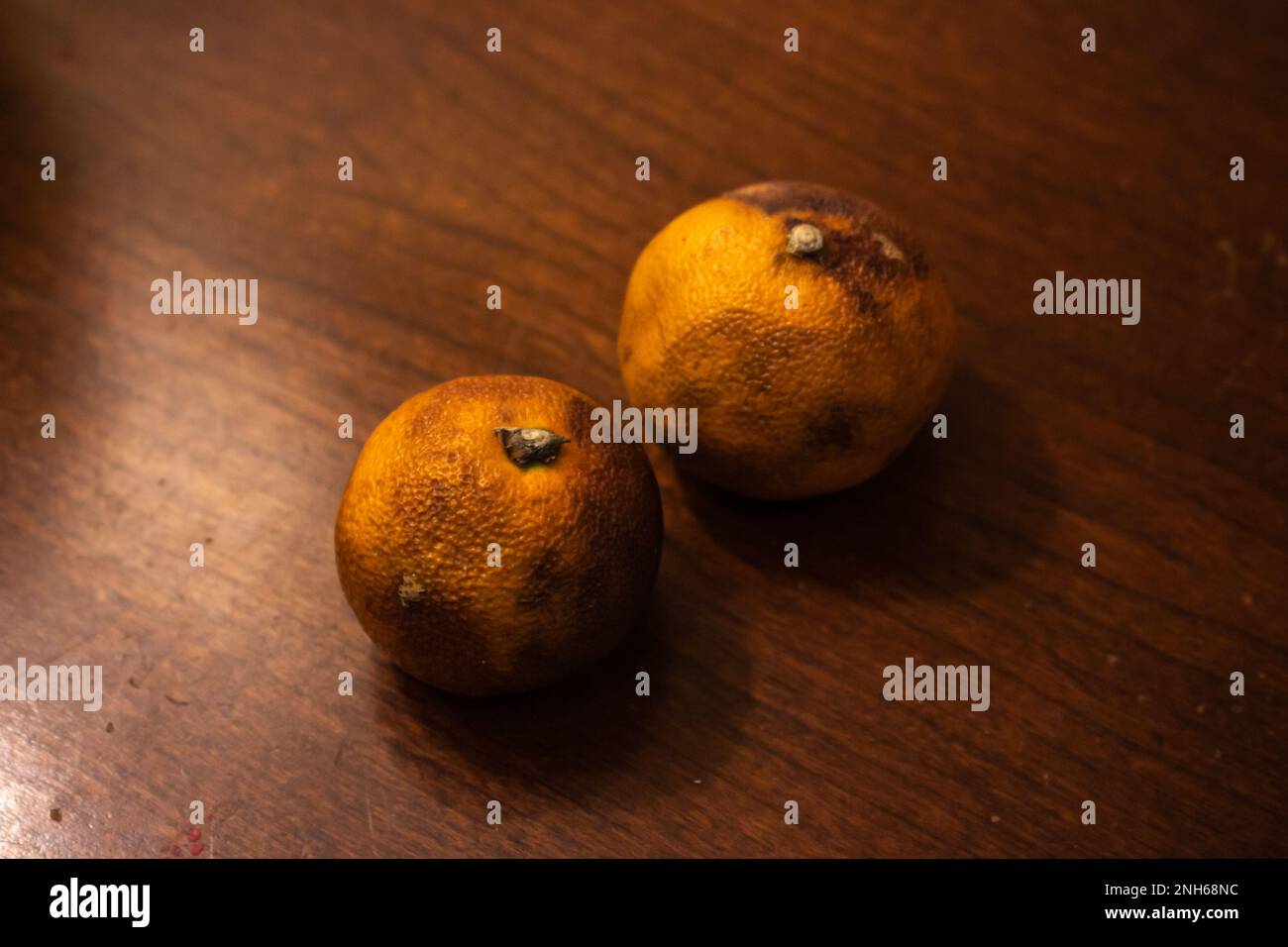 Mandarin oranges on wooden table. Orange in image have gone a little