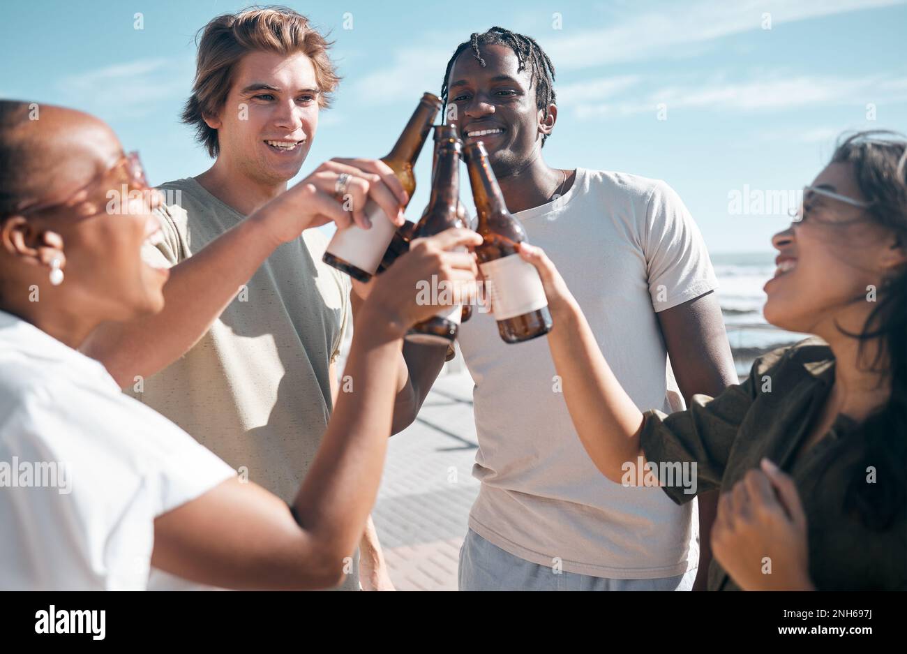 Cheers, beer and friends at the beach on a vacation, adventure or ...