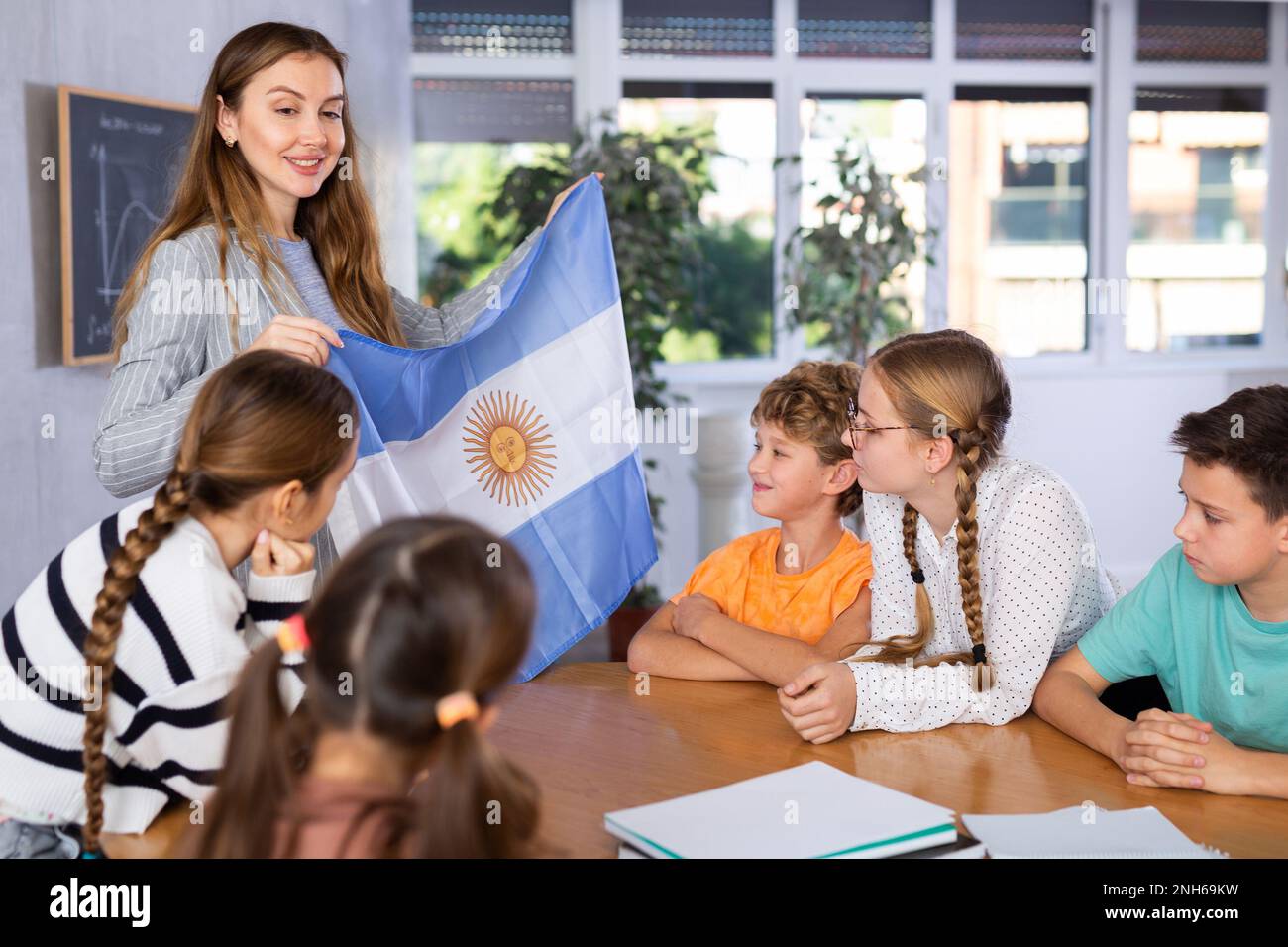 Female teacher, conducting extracurricular lesson in the school class