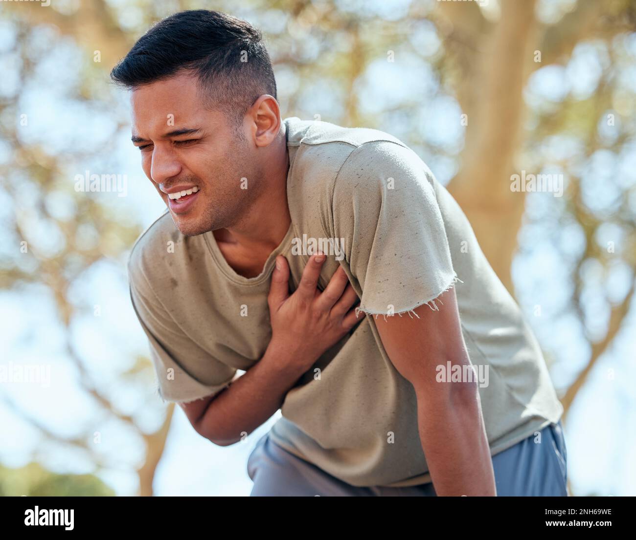 Man, runner and heart attack pain in nature while running outdoors for