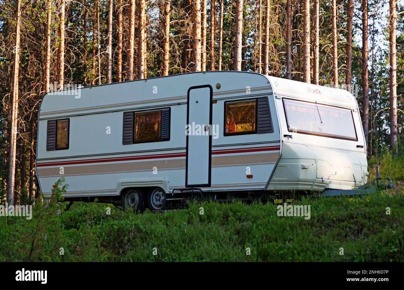 Lycksele, Norrland Sweden - July 24, 2021: large caravan parked in the forest Stock Photo