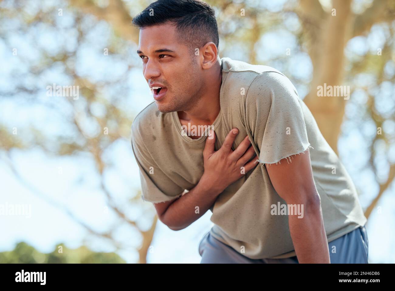 Man, runner and heart attack pain in nature while running outdoors for