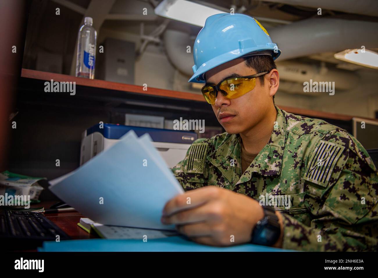 220719-N-IP029-1026 PORTSMOUTH, Va. (Jul. 19, 2022) Personnel Specialist Seaman Recruit Joseph O’Donnell, from Centreville, Virginia, reviews paperwork aboard the Nimitz-class aircraft carrier USS Dwight D. Eisenhower (CVN 69). Ike is currently pierside at Norfolk Naval Shipyard in the basic phase of the optimized fleet response plan (OFRP). Stock Photo