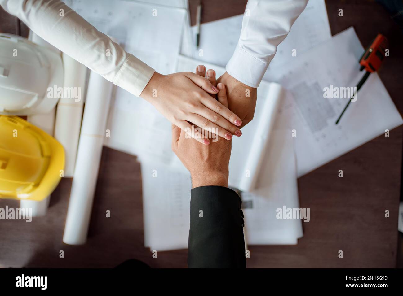 Architects and engineers teamwork join hands together,construction