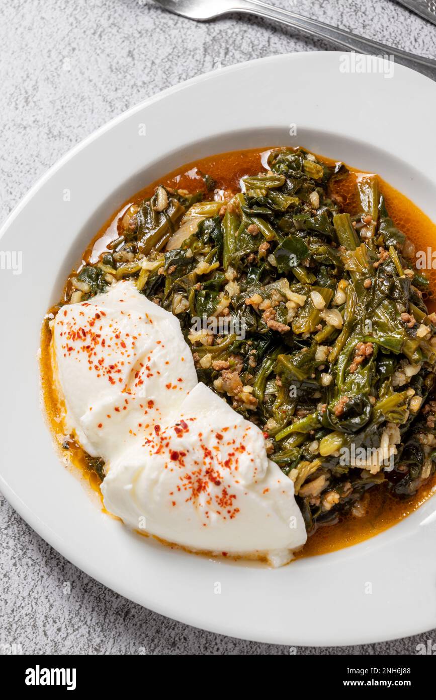 Traditional Turkish spinach meal with rice and minced meat with yogurt