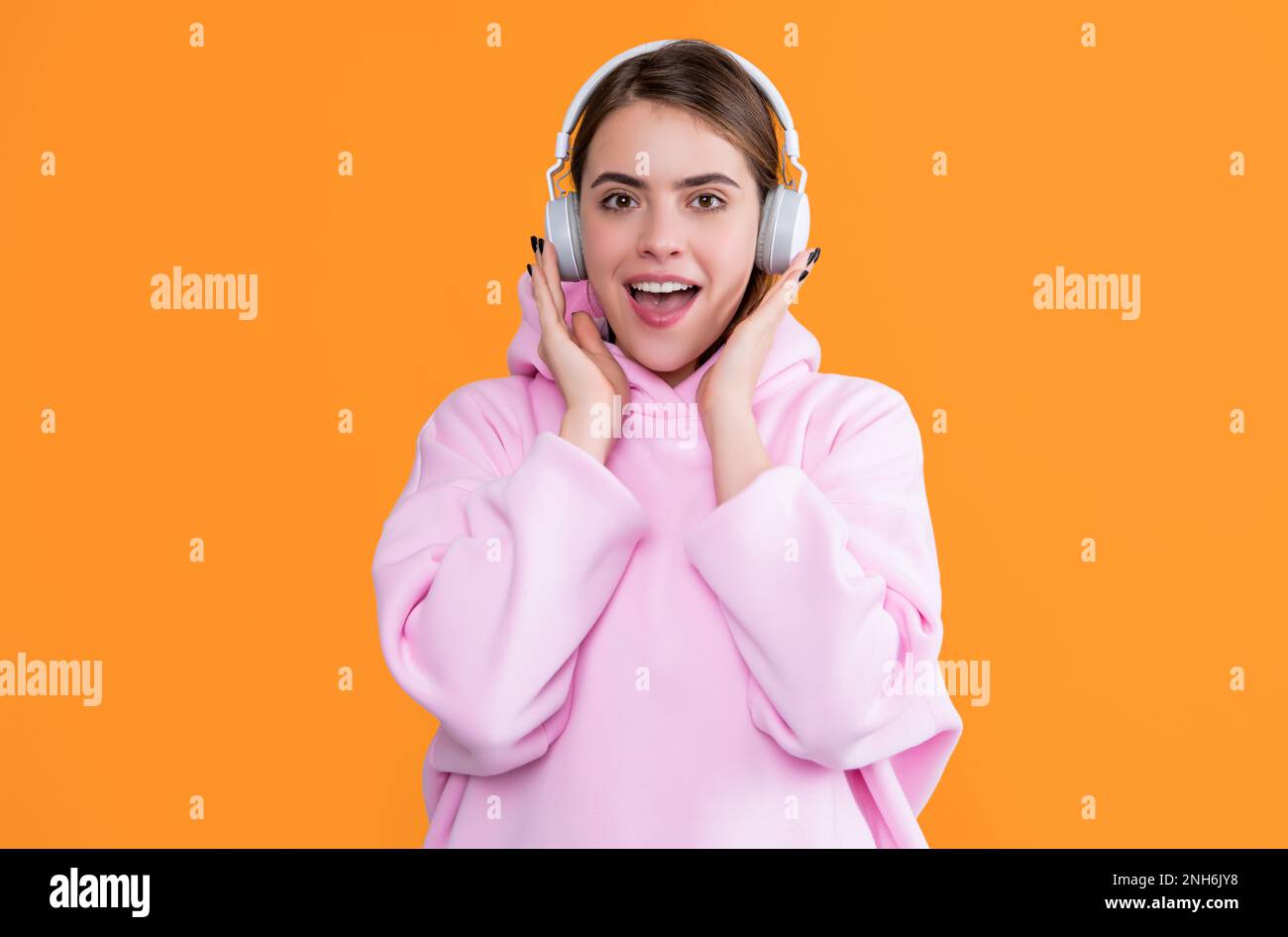 positive girl listen music in headphones on yellow background Stock ...