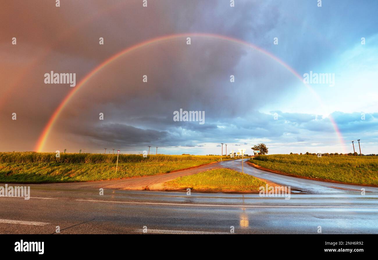 Rainbow over road Stock Photo