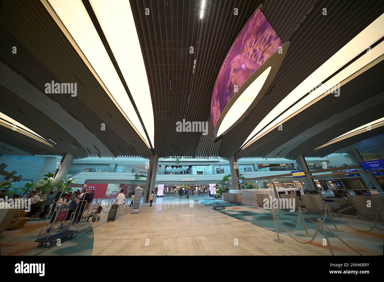 Plush interiors and check-in counters at departure hall Terminal 2, Singapore Changi Airport, February 2023 Stock Photo