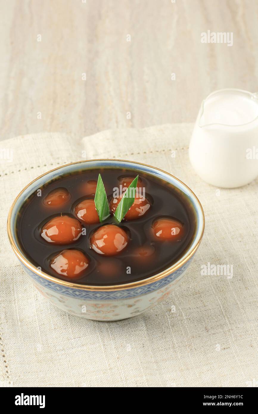 Kolak Biji Salak or Bubur Candil Ubi, Sticky Rice Flour Balls Served with Palm Sugar Syrup and COconut Milk. Popular during Ramadan. Stock Photo
