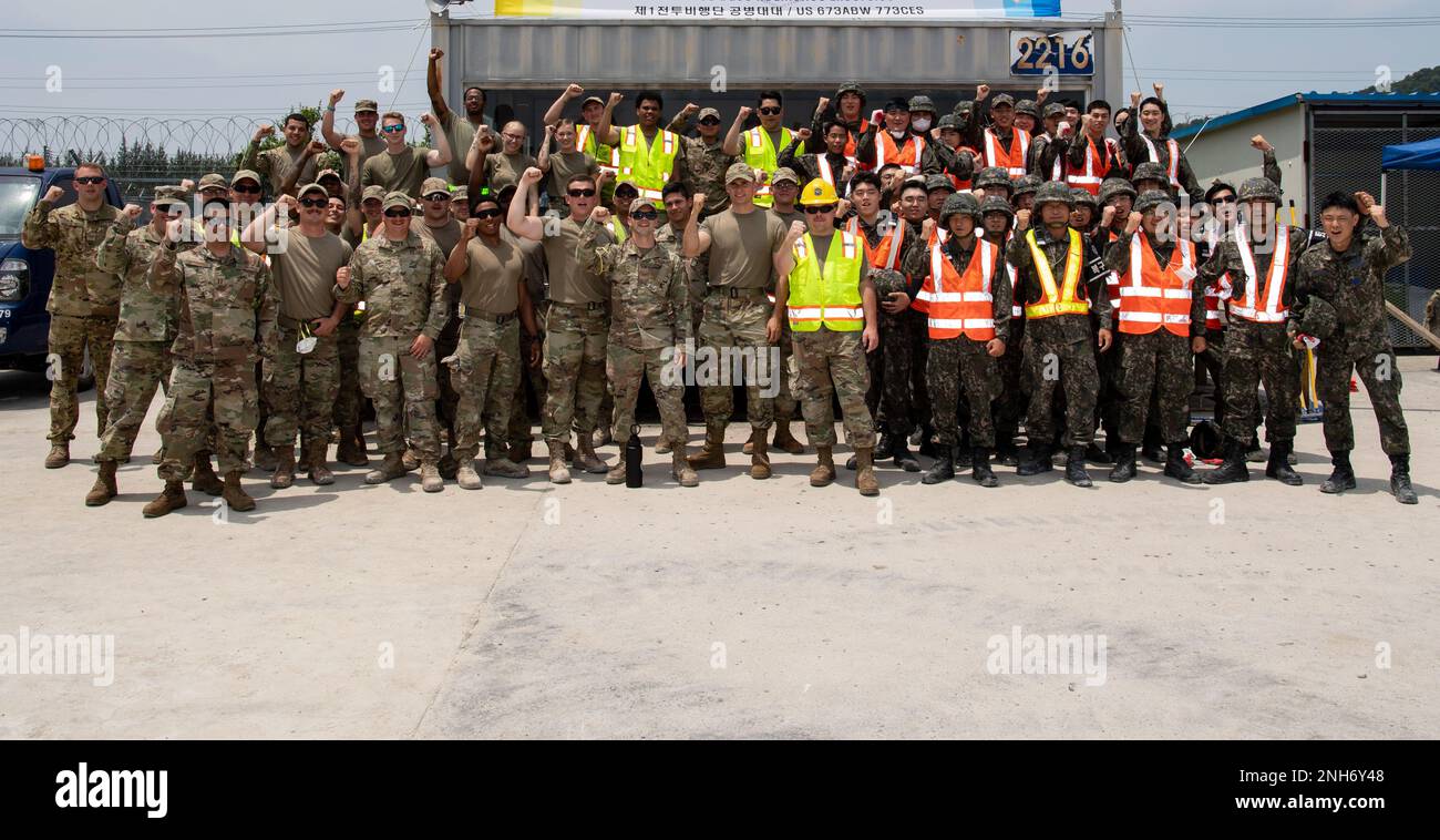 Civil Engineers from the United States Air Force (USAF) and Republic of Korea Air Force (ROKAF) stand for a group photo during a rapid airfield damage repair training, July 20, 2022 at Gwangju Air Base, Republic of Korea. During the combined training, members from the ROKAF and U.S. Air Force worked together to repair a damaged cement training pad and had the opportunity to strengthen their interoperability. Stock Photo
