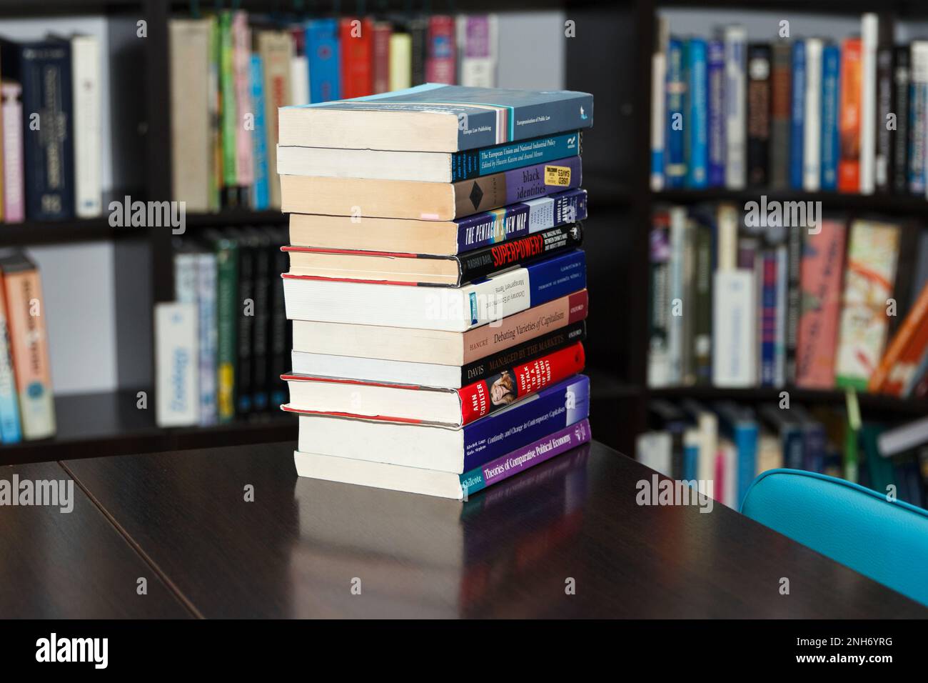 CHISINAU, MOLDOVA - MARCH 26, 2021: A stack of different specialized books in a large library selected by the reader lies on table Stock Photo
