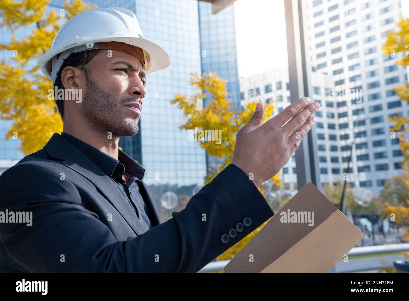 Experienced architect, constructor engineer in protective white helmet in construction. Stock Photo
