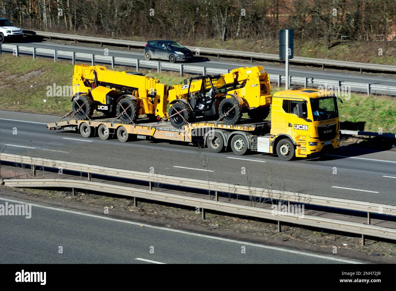 JCB low loader lorry on the M40 motorway, Warwickshire, England, UK Stock Photo