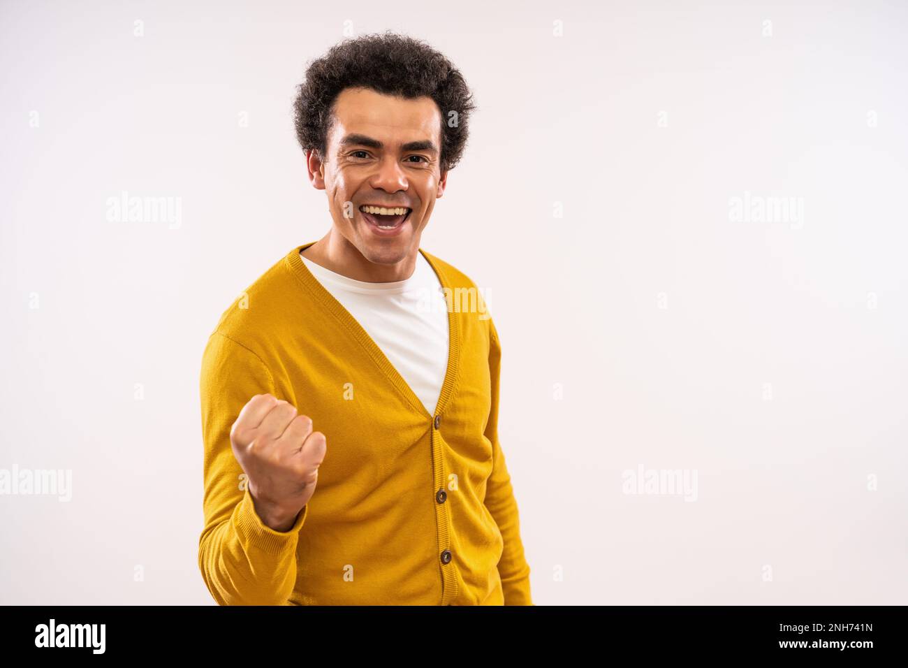 Studio shot portrait of excited smiling multiracial man. Stock Photo
