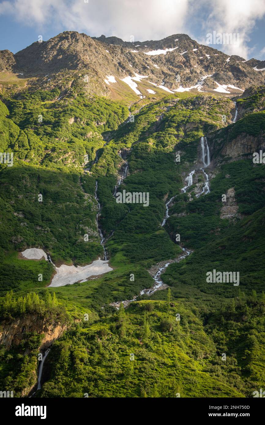 A waterfall running down the mountain Stock Photo - Alamy