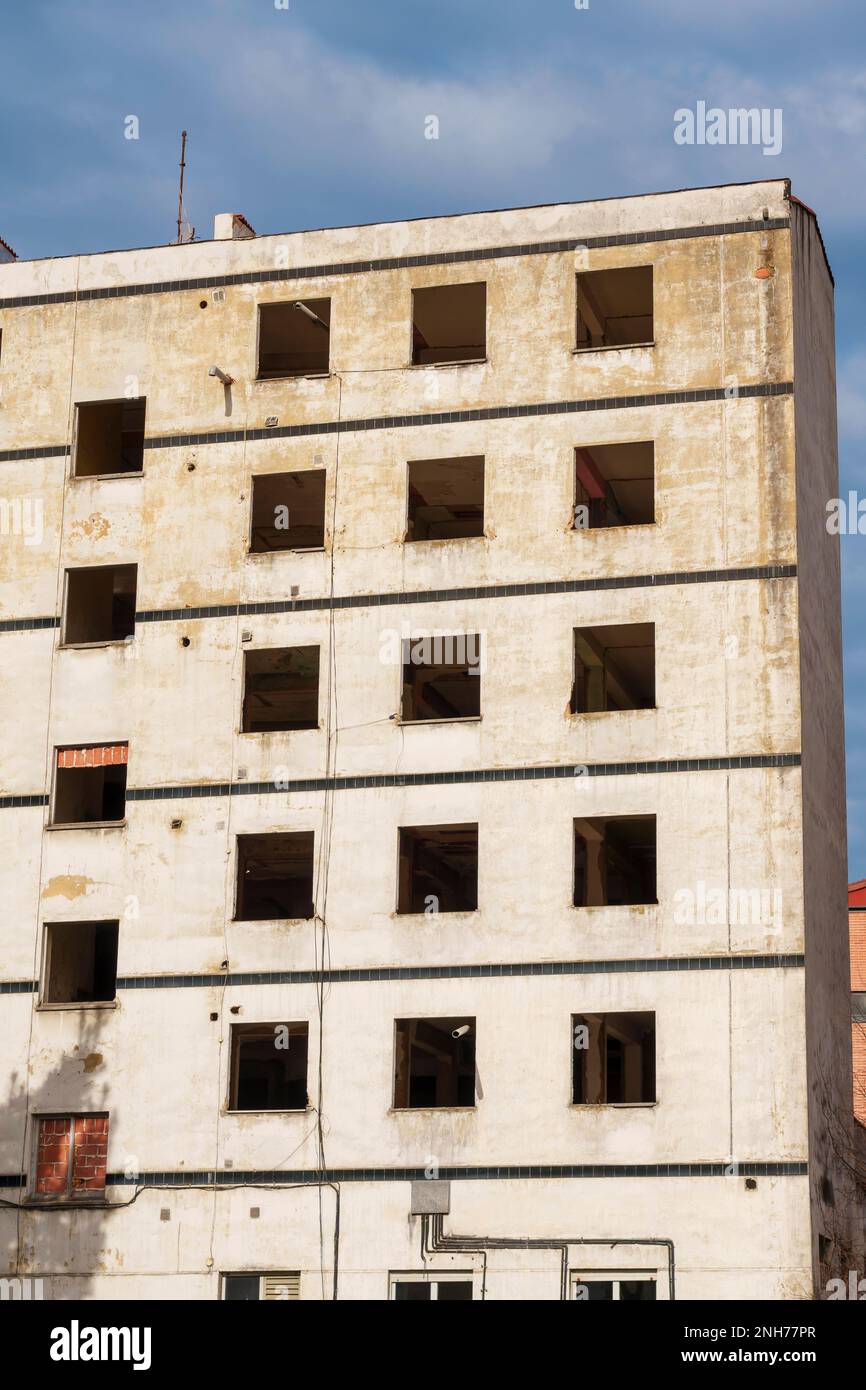 Earthquake destroyed house with broken windows and empty dramatic