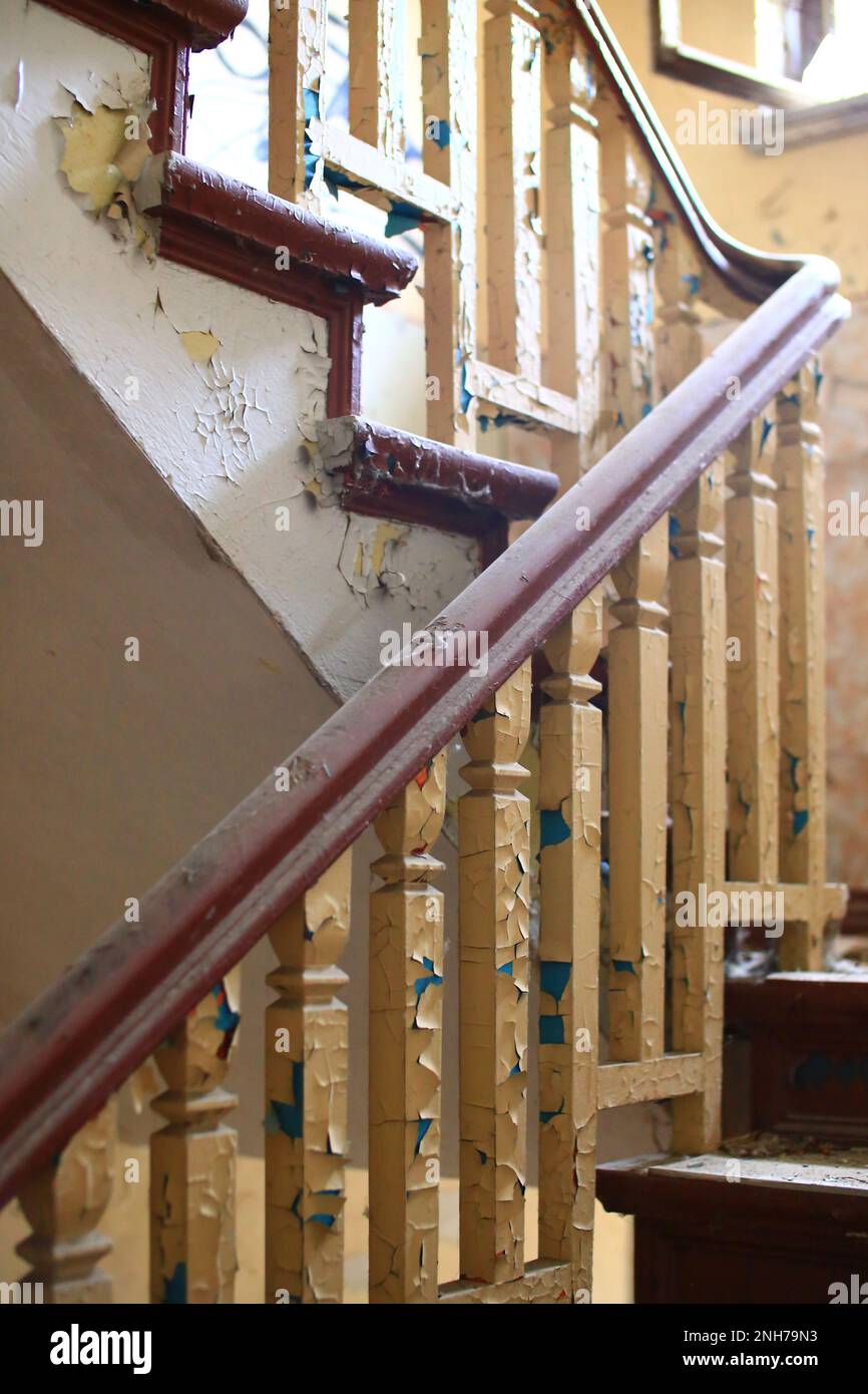 Destroyed staircase railing in an abandoned building. Stock Photo
