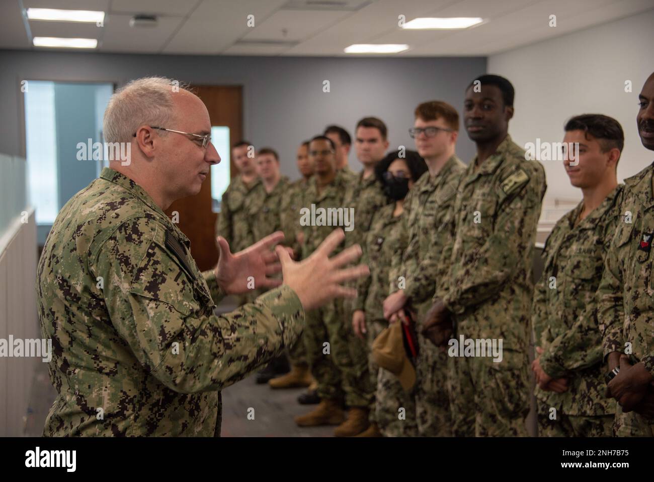 220721-N-XK809-1076 FORT GEORGE G. MEADE, Md. (July 21, 2022) Rear Adm. Stephen Donald, left, Vice Commander, U.S. Fleet Cyber Command / U.S. 10th Fleet (FCC/C10F), speaks to U.S. Navy Reserve Sailors during Phase II of Operation Cyber Dragon. During Operation Cyber Dragon Reserve Sailors assigned FCC/C10F, conduct scanning of the Navy's unclassified network to identify, remediate and implement corrective actions to reduce vulnerabilities. Stock Photo