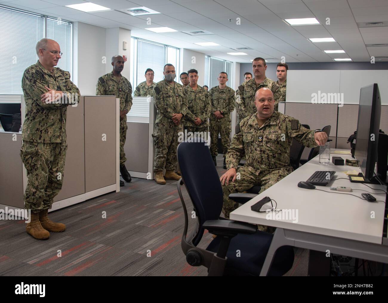 220721-N-XK809-1006 FORT GEORGE G. MEADE, Md. (July 21, 2022) U.S. Navy Reserve Sailor, Intelligence Specialist 1st Class Daniel Boatwright, right, from Tallahassee, presents vulnerabilities found during phase II of Operation Cyber Dragon to Rear Adm. Stephen Donald, left, Vice Commander, U.S. Fleet Cyber Command / U.S. 10th Fleet (FCC/C10F). During Operation Cyber Dragon Reserve Sailors assigned U.S. Fleet Cyber Command/U.S. 10th Fleet, conducted scanning of the Navy's unclassified network to identify, remediate and implement corrective actions to reduce vulnerabilities. Stock Photo