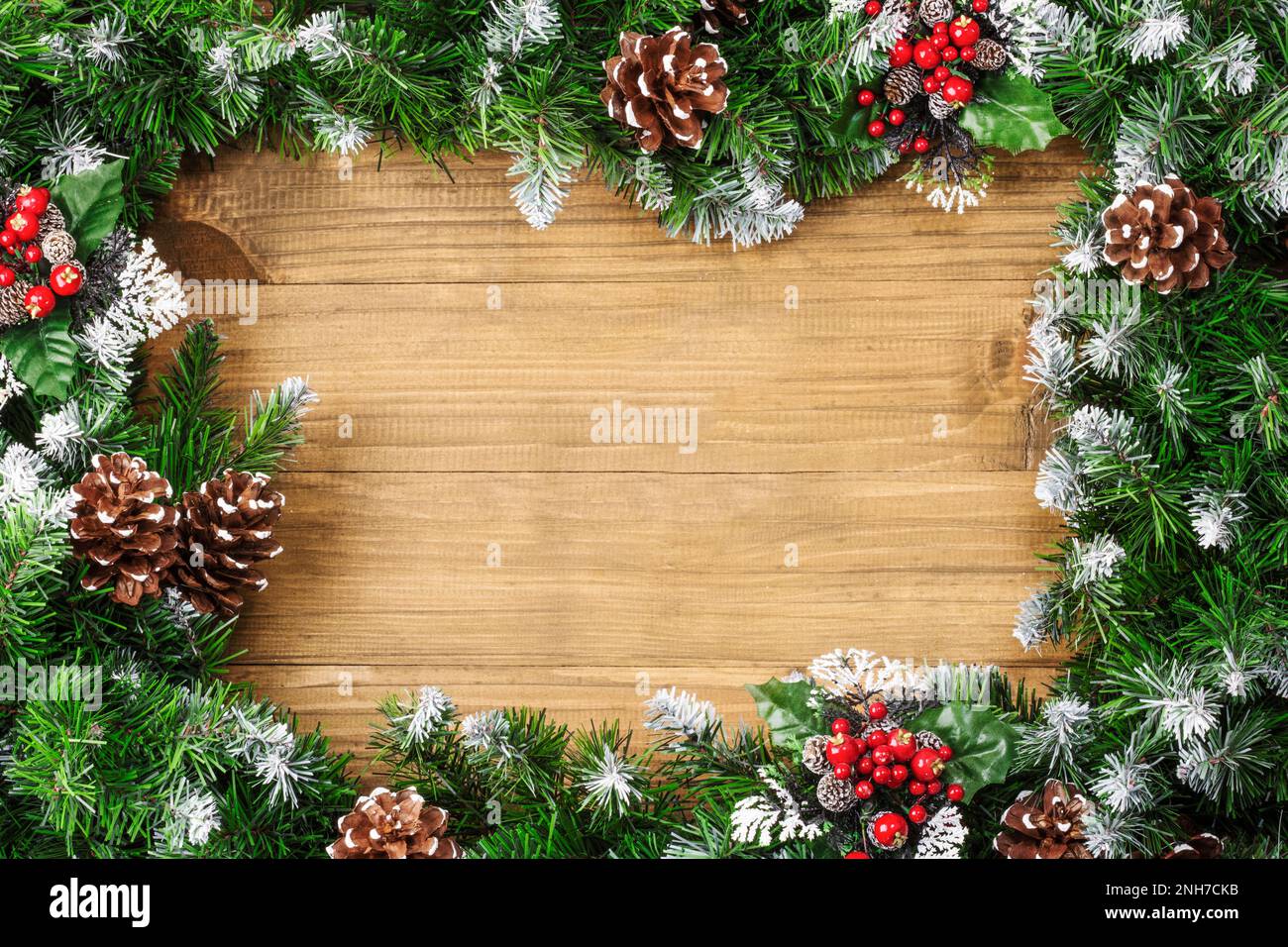 Christmas border composed of snow-covered fir branches and cones on ...
