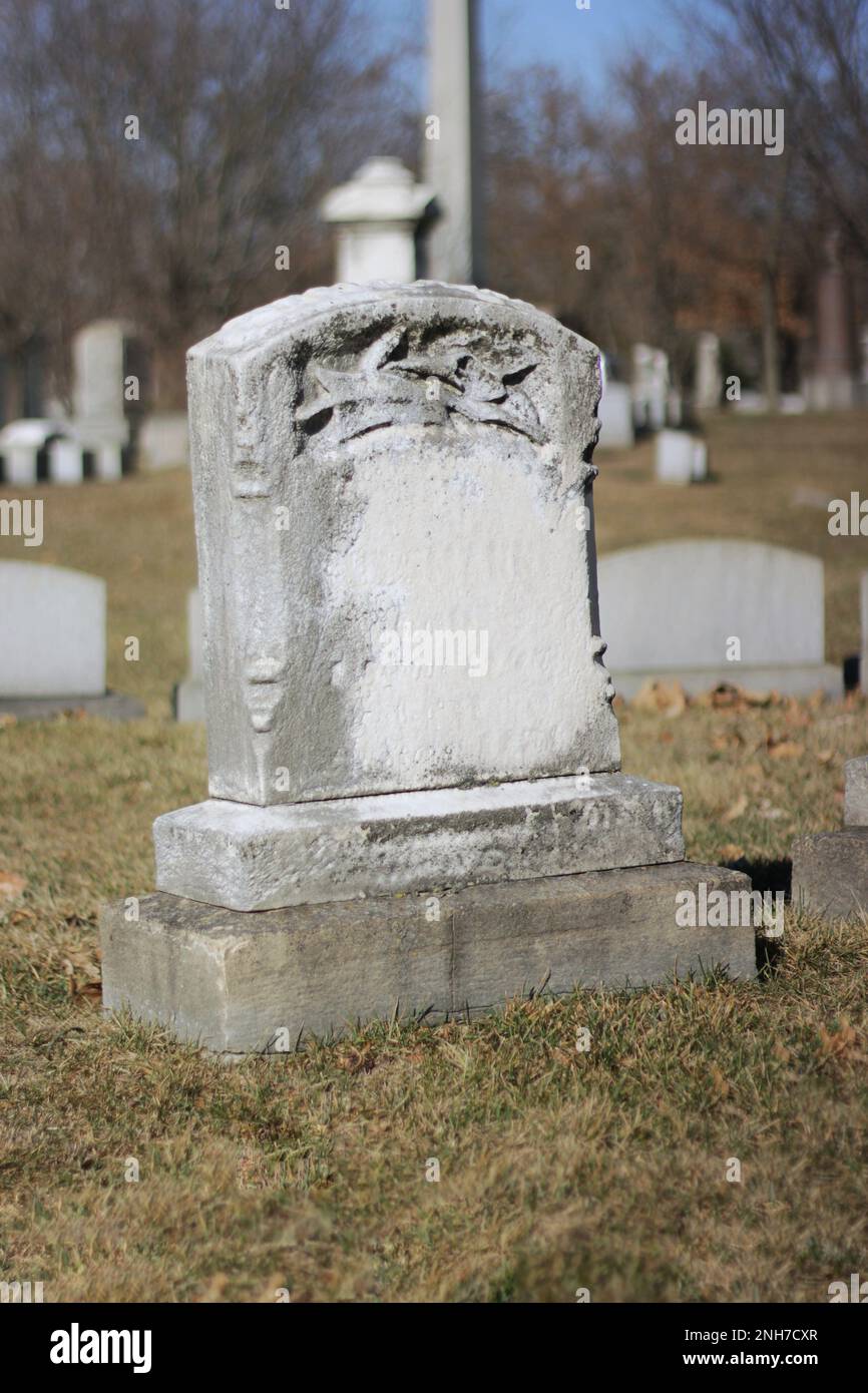 Typical common worn and weathered limestone tombstone with a blank