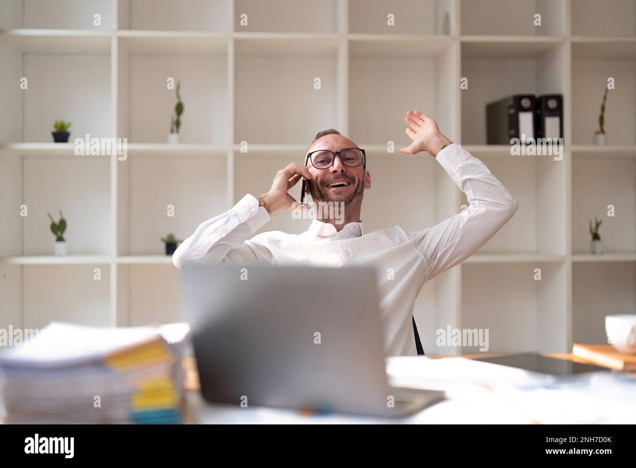 Businessman Making Phone Call Sitting At Office Stock Photo - Alamy