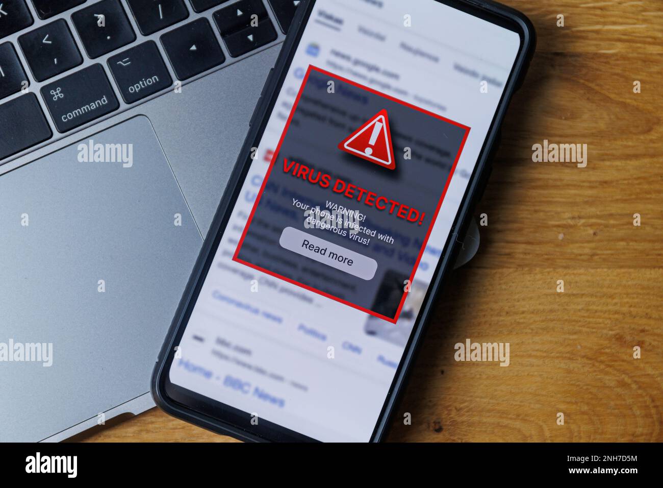 Virus warning notification on phone screen. Dangerous malware virus in phone Concept Stock Photo