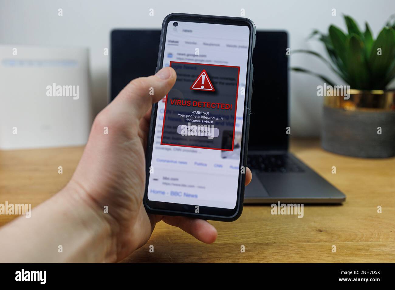 Virus warning notification on phone screen. Dangerous malware virus in phone Concept Stock Photo