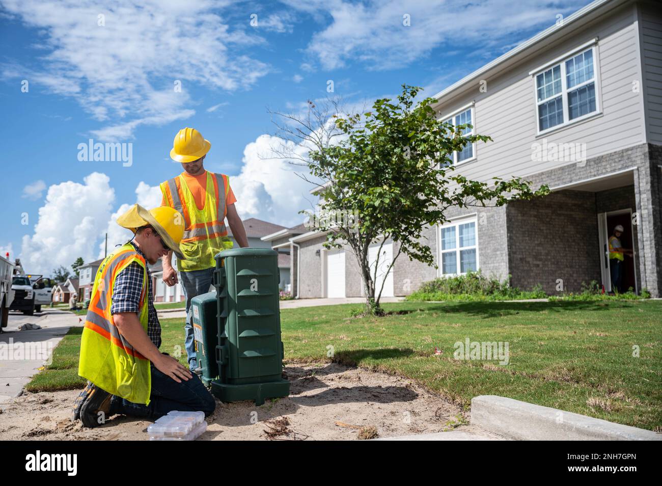 Contractors install an electrical box at Tyndall Air Force Base