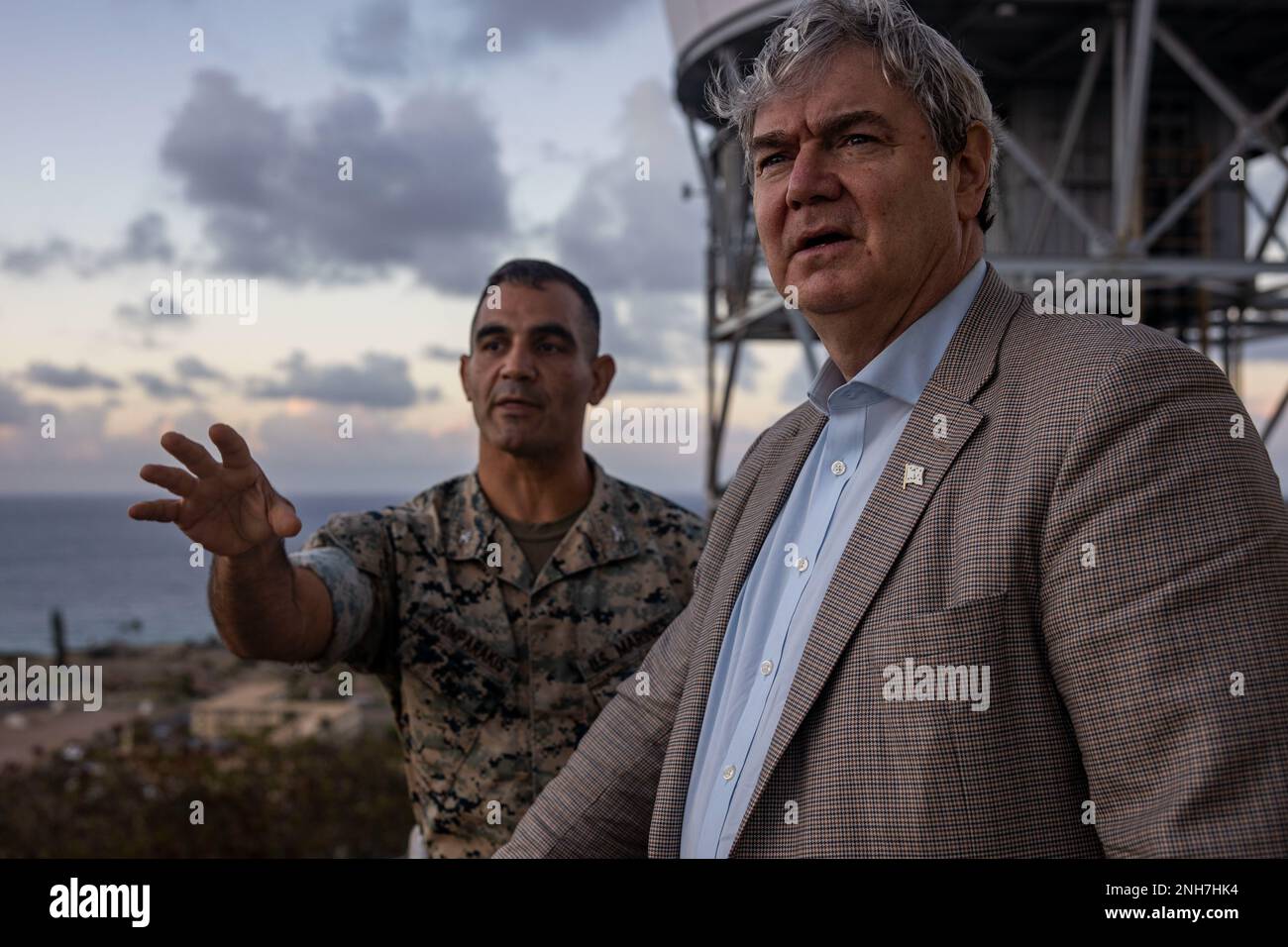 The Honorable John P. Coffey, left, head of the office of the General Counsel, Department of the Navy, and U.S. Marine Corps Col. Speros Koumparakis, commanding officer, Marine Corps Base Hawaii, overlook the base and discuss oncoming developments during a visit to MCBH, July 21, 2022. The purpose of the visit was to inform Mr. Coffey on the base’s progression toward Force Design 2030. Stock Photo