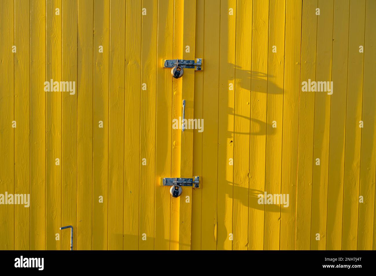 Yellow beach hut on the beach at Walton on the Naze Essex Stock Photo