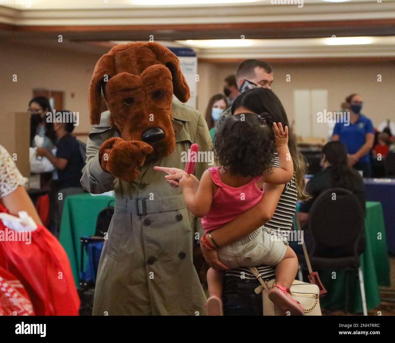 A child waves to McGruff the Crime Dog from the Marine Corps Law