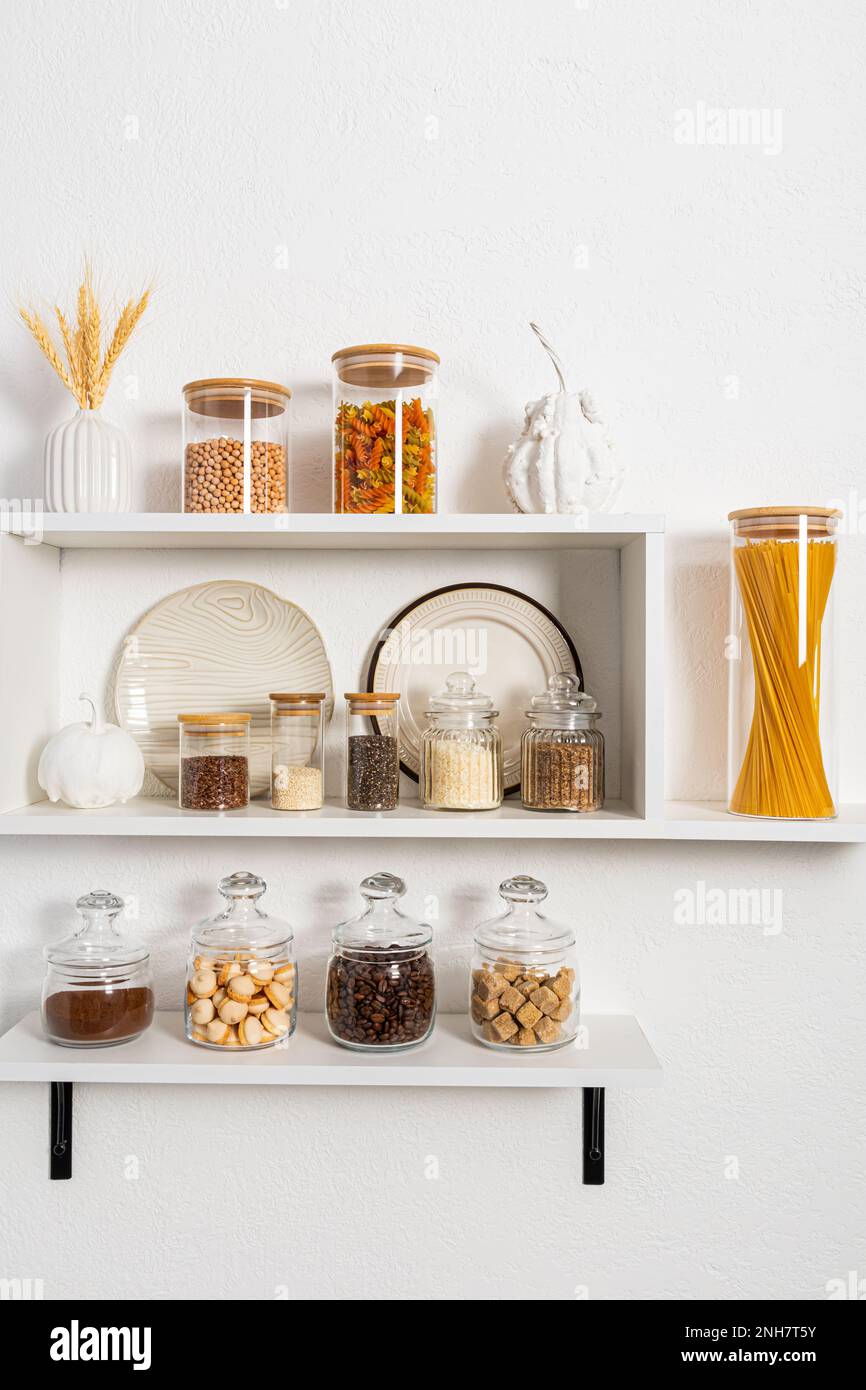 many different glass filled ecobanks for storing bulk products stand