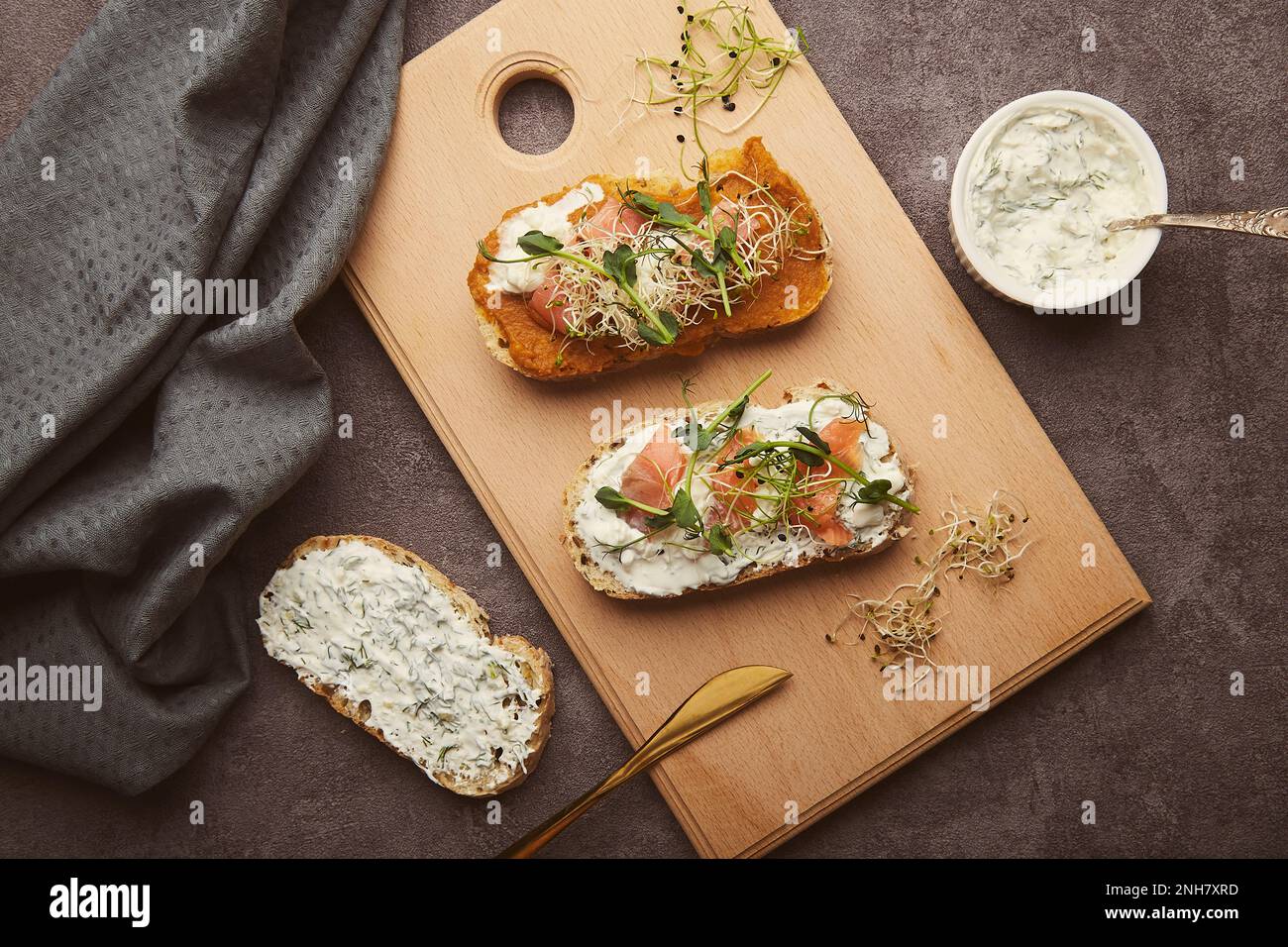Sandwiches with zucchini spread, salmon and sour cream garlic sauce. Low in calories healthy breakfast. Stock Photo