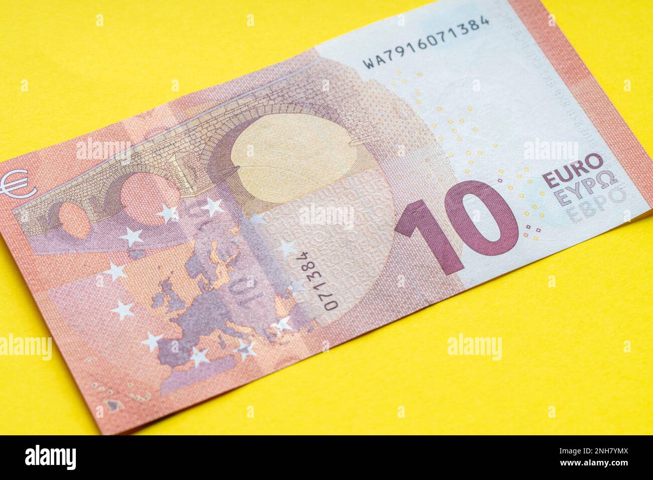 10 euro banknote close up, yellow background for business finance ...
