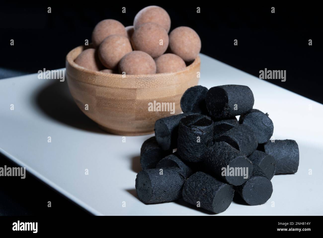 Helsinki / Finland - FEBRUARY 21, 2023 - Traditional Finnish cuisine: A closeup of the traditional Finnish delicacy of black licorice against a dark b Stock Photo