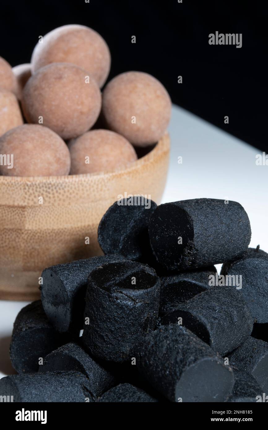 Helsinki / Finland - FEBRUARY 21, 2023 - Traditional Finnish cuisine: A closeup of the traditional Finnish delicacy of black licorice against a dark b Stock Photo