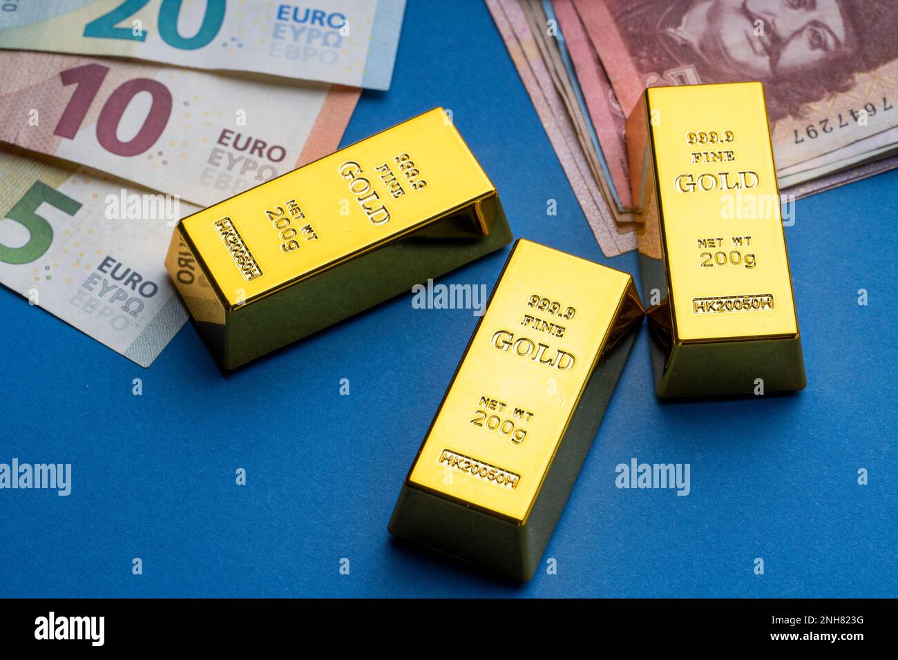 There are Hungarian forints and euro banknotes on a flat surface. A  calculator, gold blocks, and bitcoin coins are laid out next to it. HUF EUR  exchan Stock Photo - Alamy